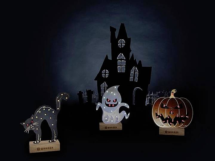 Czarna kotka, duch i dynia z nietoperzami przed mrocznym nawiedzonym domem na ciemnym tle.