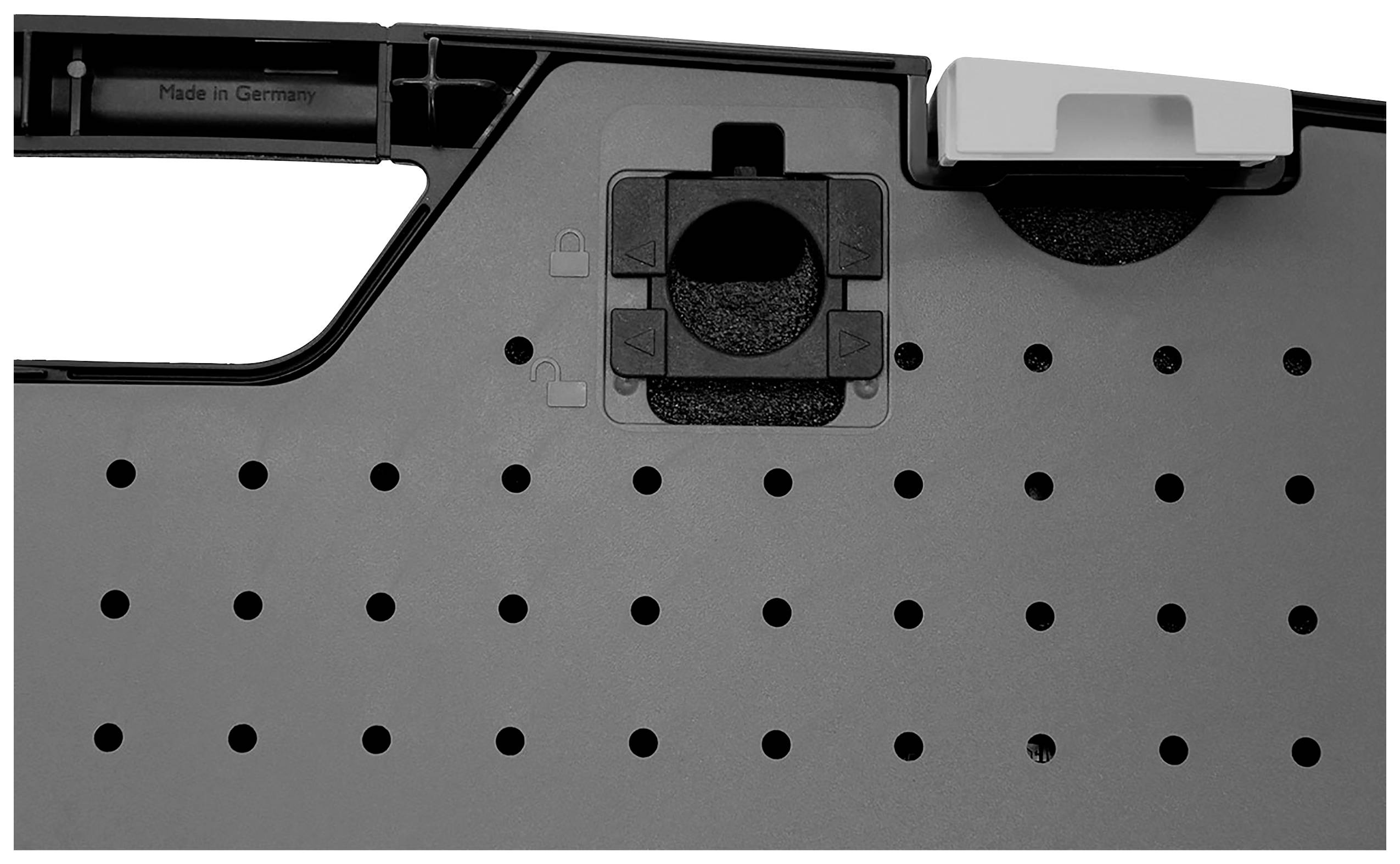 Zbliżenie szarej obudowy plastikowej z perforowanym wzorem i małym przesuwnym regulatorem, na którym widnieje napis 'Made in Germany'.