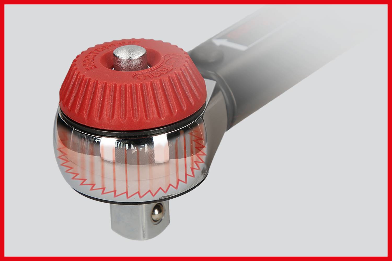 Grzechotka z czerwonym pokrętłem i przezroczystą obudową prezentuje mechanizm. Srebrne pokrętło na górze, szare tło.