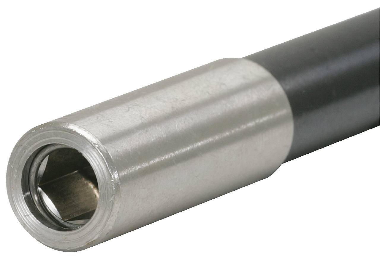 Metalowa rura z srebrnym i czarnym pokryciem, ukazująca otwarte, sześciokątne wejście.