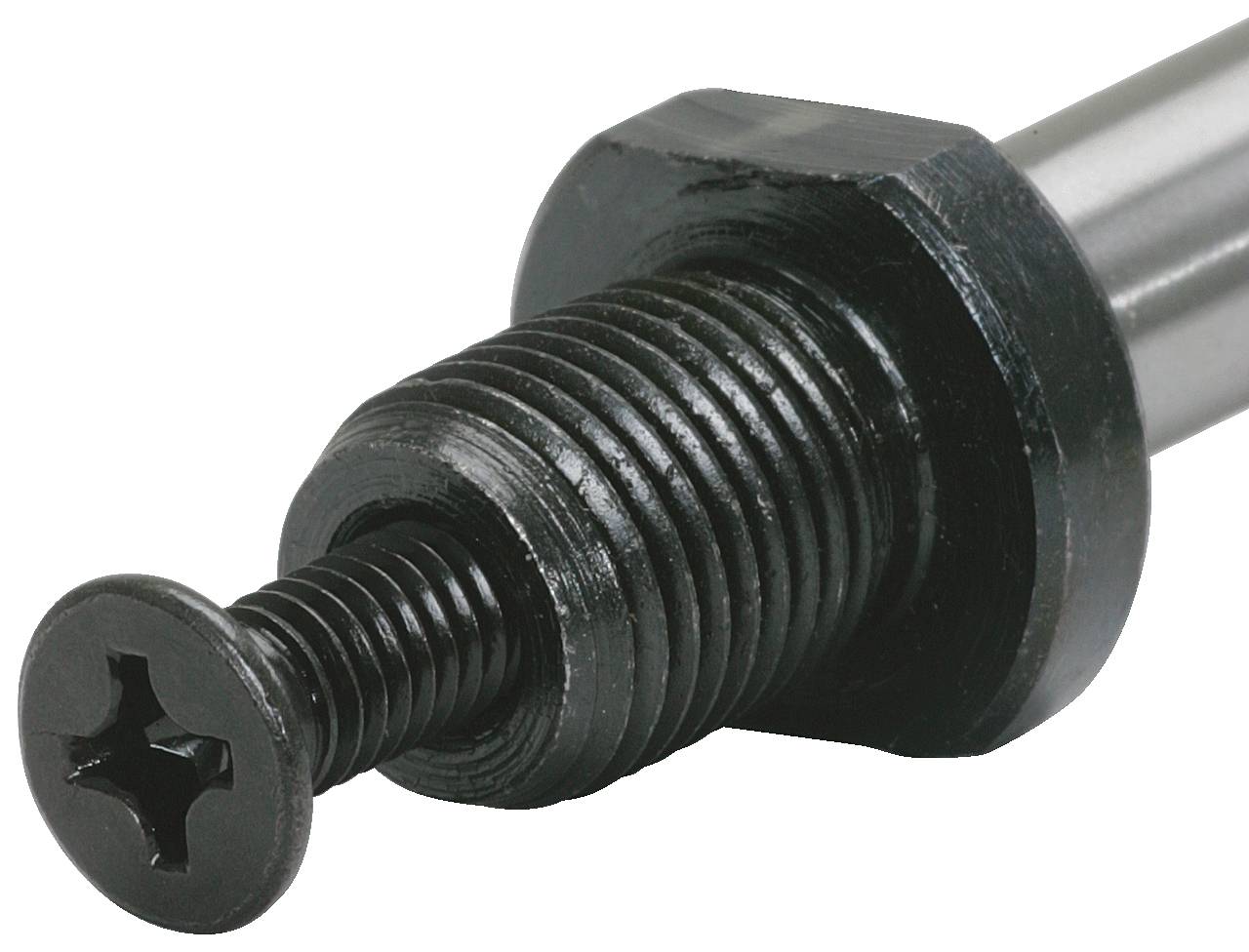 Zbliżenie czarnego gwintu śruby z łbem krzyżowym. Śruba jest zamocowana na metalowym cylindrze.