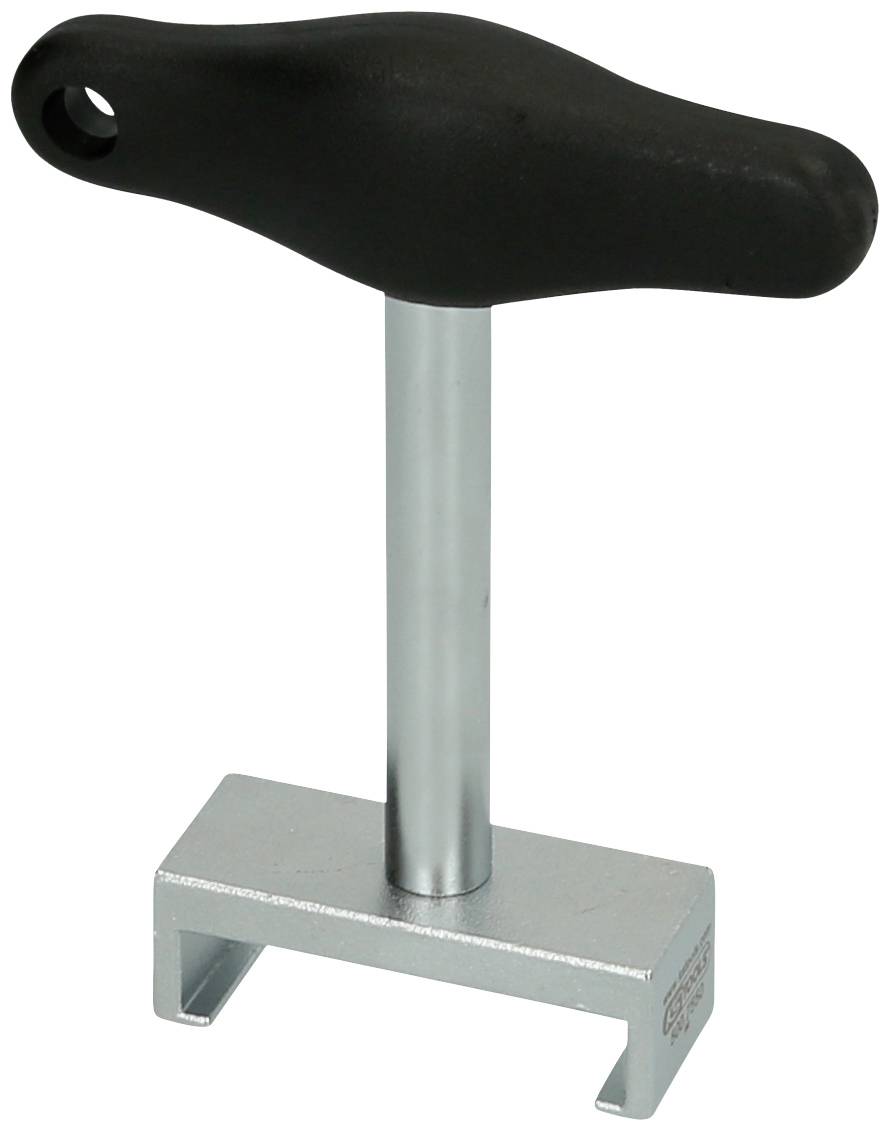 Klucz trapezowy z czarnym uchwytem T i srebrnym korpusem metalowym. Używany do zabezpieczania części akcesoriów.