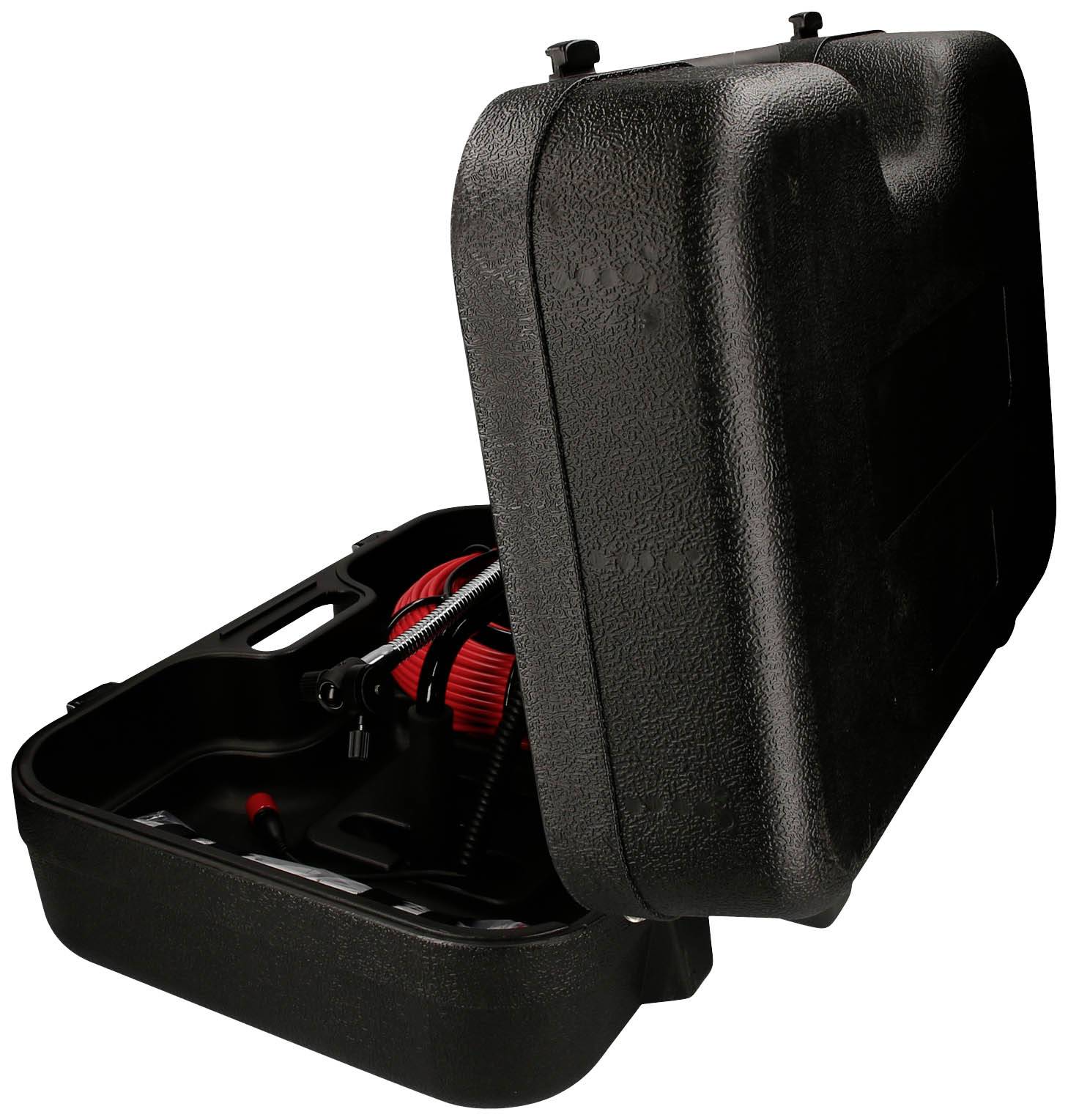 Otwarty czarny kufer z czarnym i czerwonym urządzeniem w środku, prawdopodobnie narzędziem lub sprzętem.