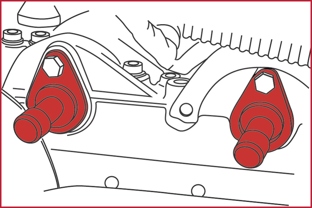 Czerwone śruby na szarej grupie montażowej maszyny ze szczegółami technicznymi. Ręka widoczna u góry wskazuje na elementy.