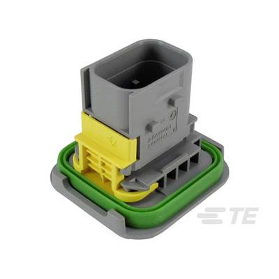 'Szary i żółty złącz elektroniczny z zieloną uszczelką, zamontowany na prostokątnej podstawie.'