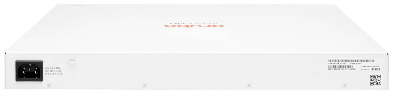 Białe urządzenie sieciowe z logo Aruba, z tyłu widoczne złącze zasilania i różne porty przyłączeniowe.