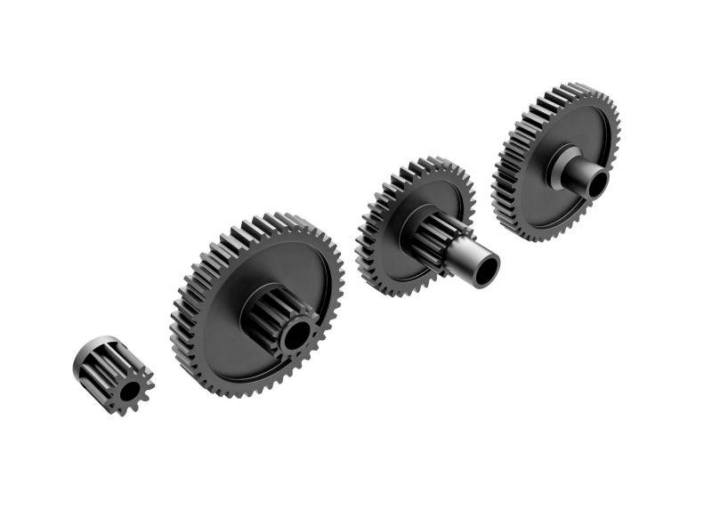 Cztery zazębiające się koła zębate o różnych rozmiarach, ilustrujące mechanizm przenoszenia siły.