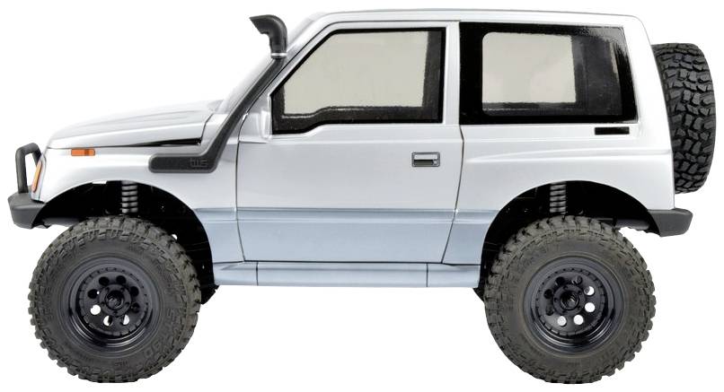 Miniaturowy samochód w stylu terenowym z dużymi oponami, srebrnym lakierem i kołem zapasowym z tyłu, przedstawiony z boku.