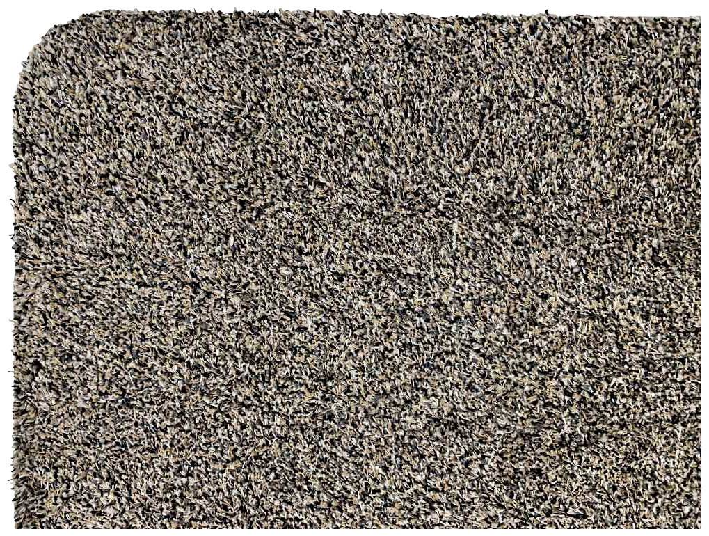 Prostokątny, brązowy dywan w nakrapianym odcieniu z zaokrągloną krawędzią po jednej stronie.