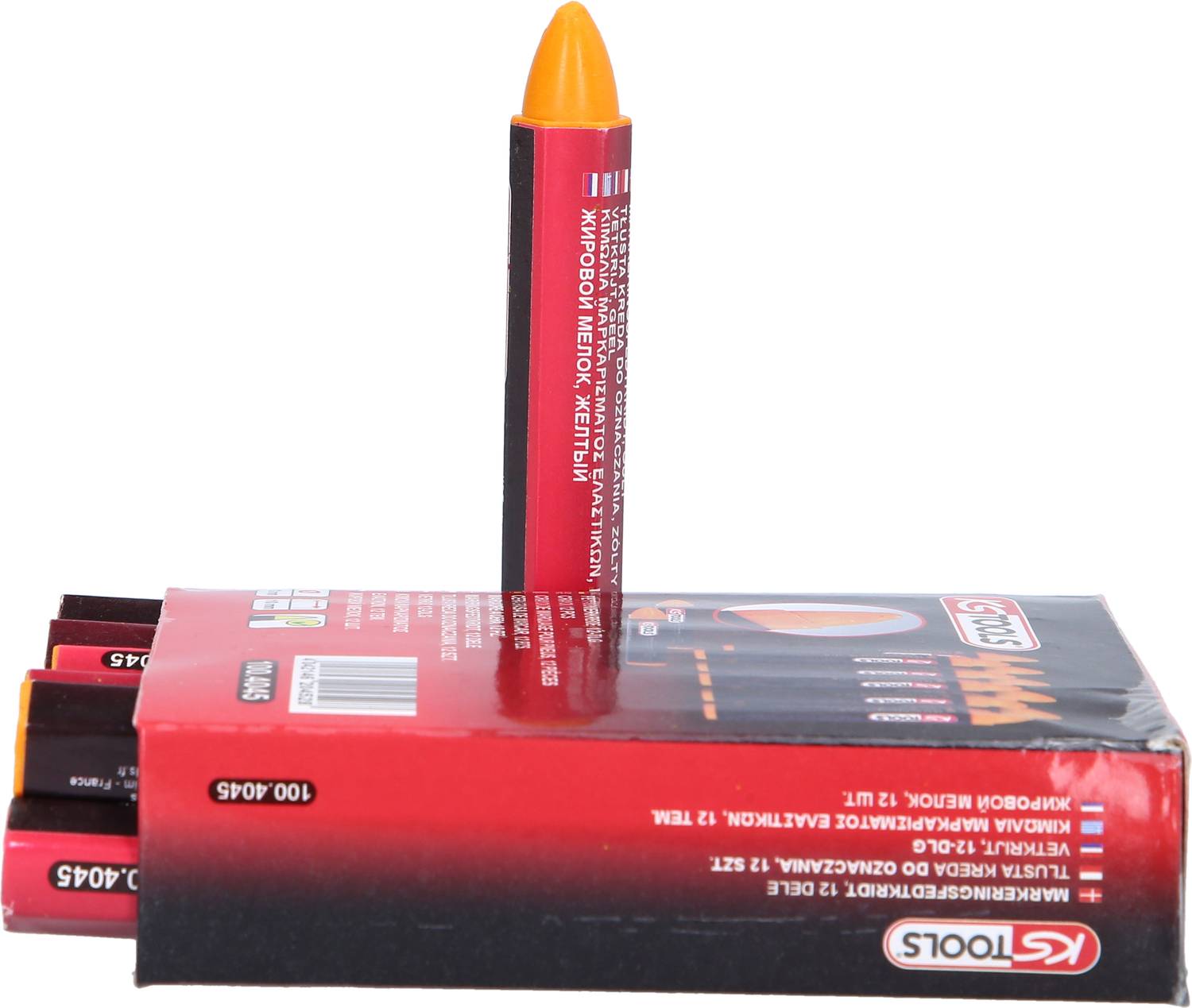 Czerwone pudełko z wydrukowanym logo 'KTOOLS' zawiera żółty kredki woskowe. Jeden kredek sterczy pionowo z pudełka.