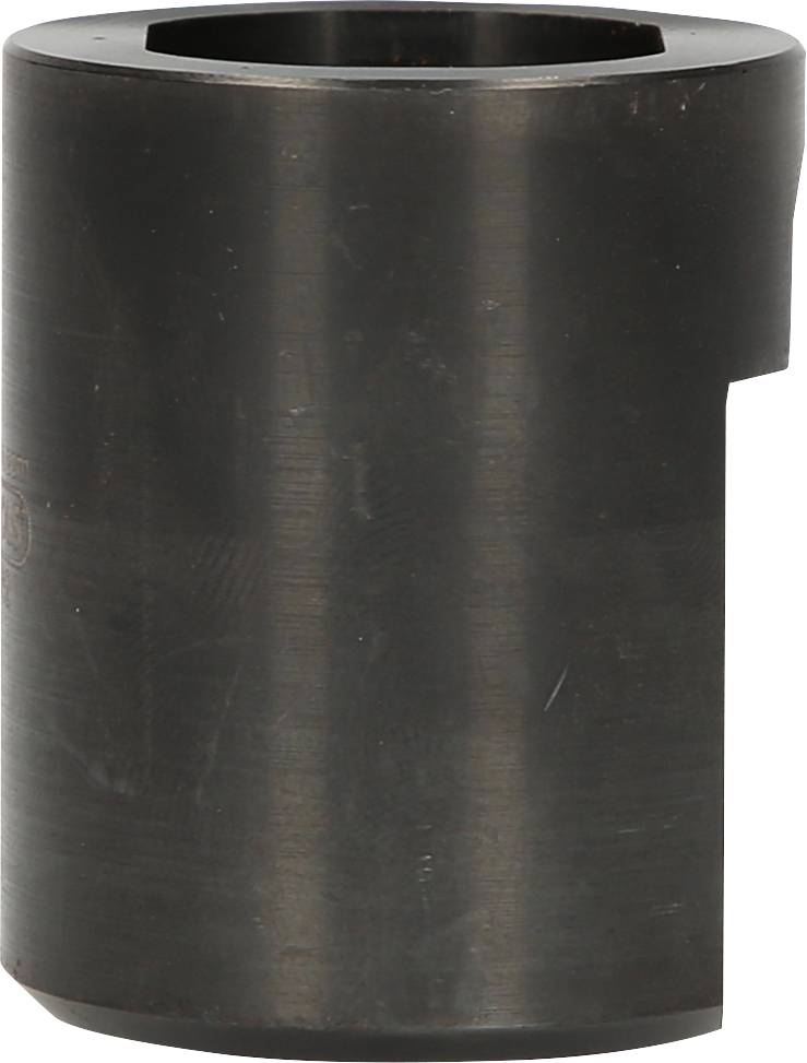 Masywny cylindryczny element metalowy o gładkiej, ciemnej powierzchni z wycięciem z boku, prawdopodobnie część stosowana w urządzeniach mechanicznych.