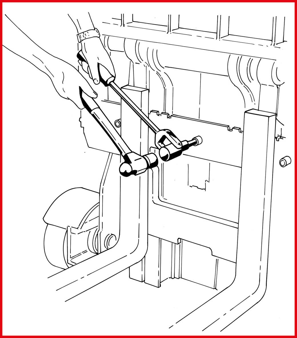 Osoba używa specjalistycznego narzędzia do regulacji mechanizmu w maszynie. Widoczne jest również koło.