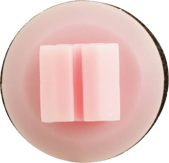 Okrągła, różowa forma silikonowa z dwoma pionowymi prostokątnymi wgłębieniami pośrodku, które wystają z materiału.