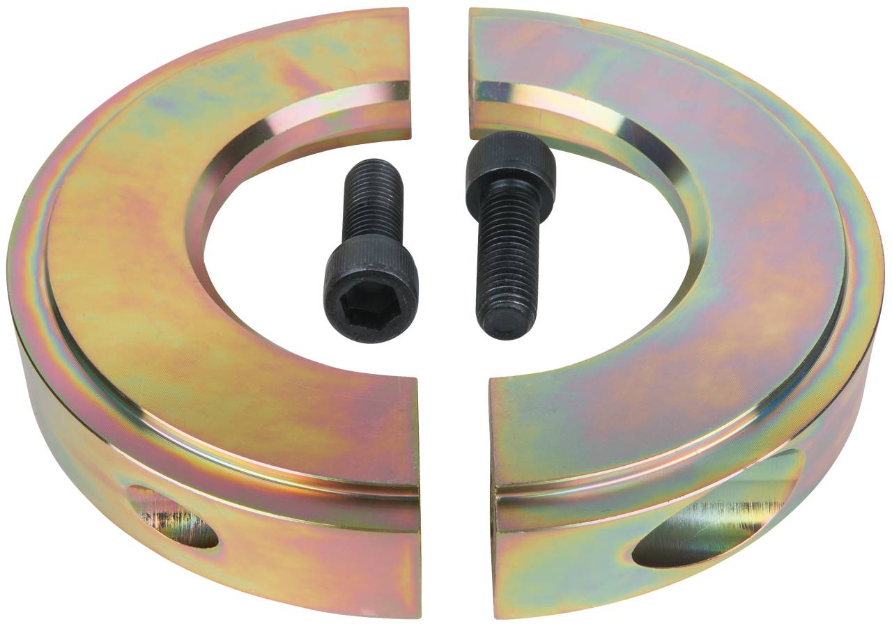 Dwa półokrągłe elementy w kolorze metalicznym z dwiema czarnymi śrubami pośrodku, na białym tle.