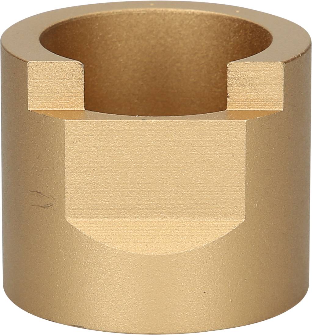 Cylindryczna metalowa część z wycięciem na górnej powierzchni. Powierzchnie w odcieniu złotym, prawdopodobnie element maszyny.