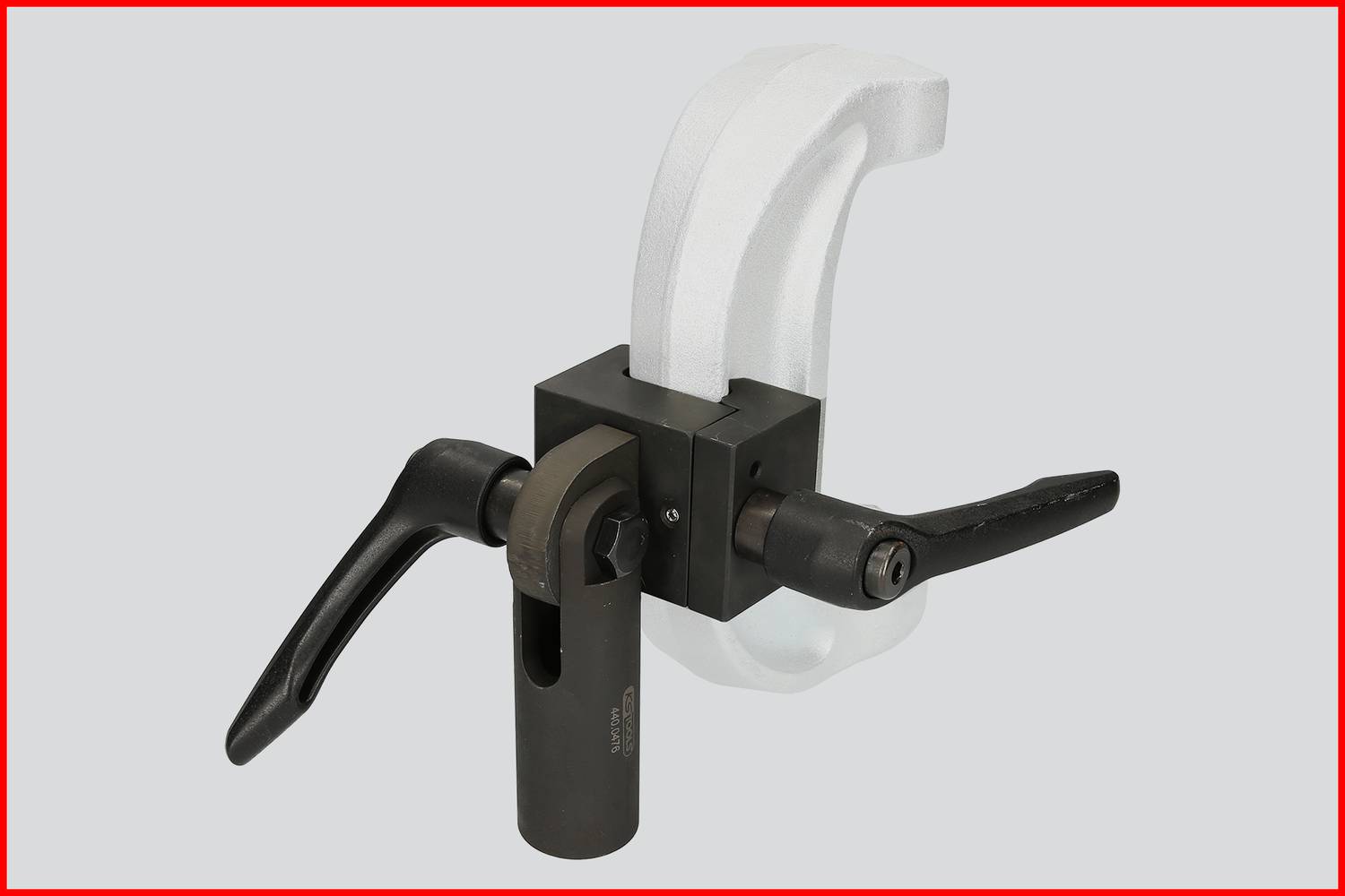 Imadło z obudową w kolorze czarnym i białym, wyposażone w dwie rękojeści, zamontowane na szarym tle, przeznaczone do precyzyjnego mocowania elementów obrabianych.