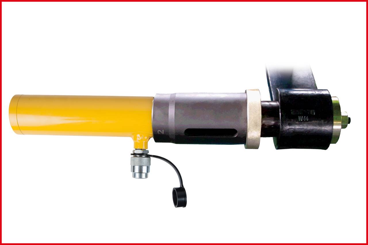 Hydrauliczny zacisk śrubowy z żółtą obudową i czarnym trzpieniem, stosowany w wysokociśnieniowych zastosowaniach podczas konserwacji.