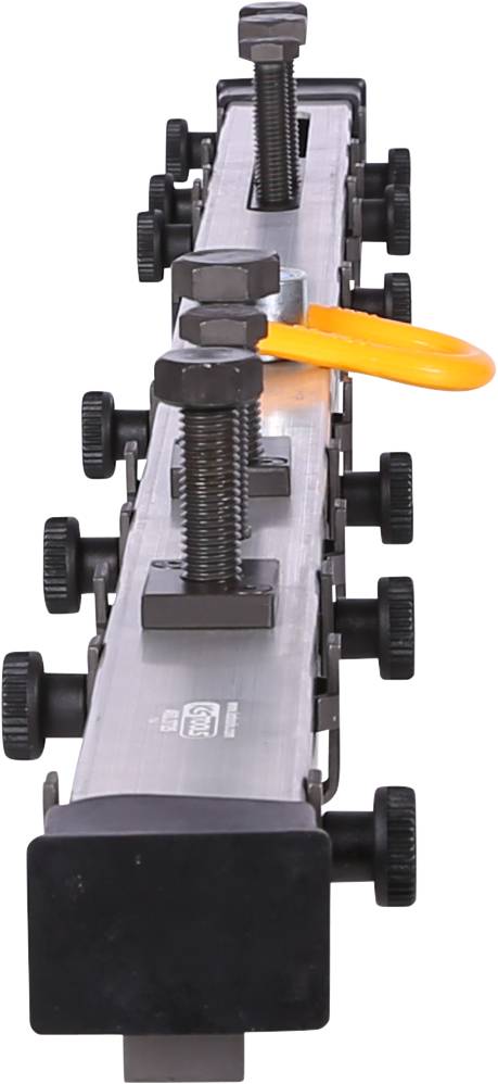 Metalowe narzędzie z kilkoma obrotowymi przyciskami i pomarańczowym klipsem, prawdopodobnie służące do mocowania.