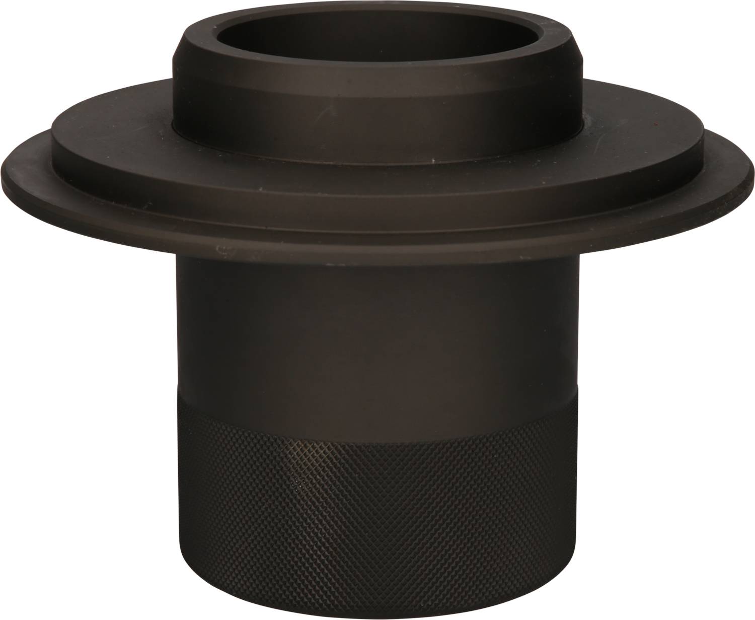 Czarny, cylindryczny element maszynowy z szerokim rantem u góry i teksturowaną powierzchnią u dołu.