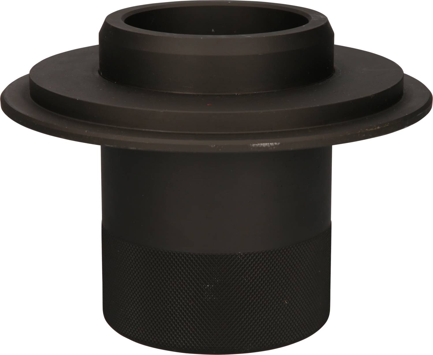 Czarny, cylindryczny, metalowy element maszyny, gładki na górze, żebrowany u dołu. Stosowany w zastosowaniach technicznych.