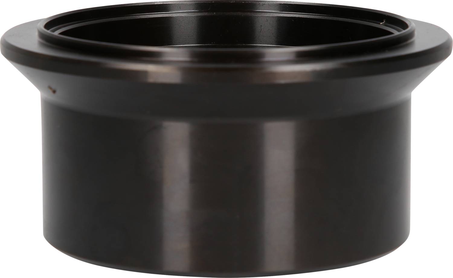 Czarny, okrągły element z tworzywa sztucznego z płaskim brzegiem i wgłębieniem pośrodku, prawdopodobnie używany jako pokrywa lub uszczelnienie.