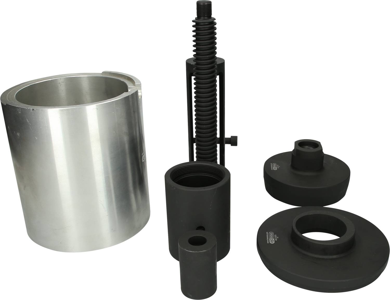 Narzędzia i komponenty metalowe: kształt cylindryczny, mechanizm śrubowy oraz kilka okrągłych elementów do zastosowań mechanicznych.