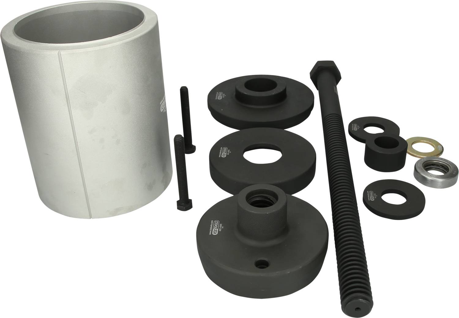 Zestaw narzędzi mechanicznych, w tym śruby, pierścienie i cylindryczny element, prawdopodobnie przeznaczony do napraw samochodowych.