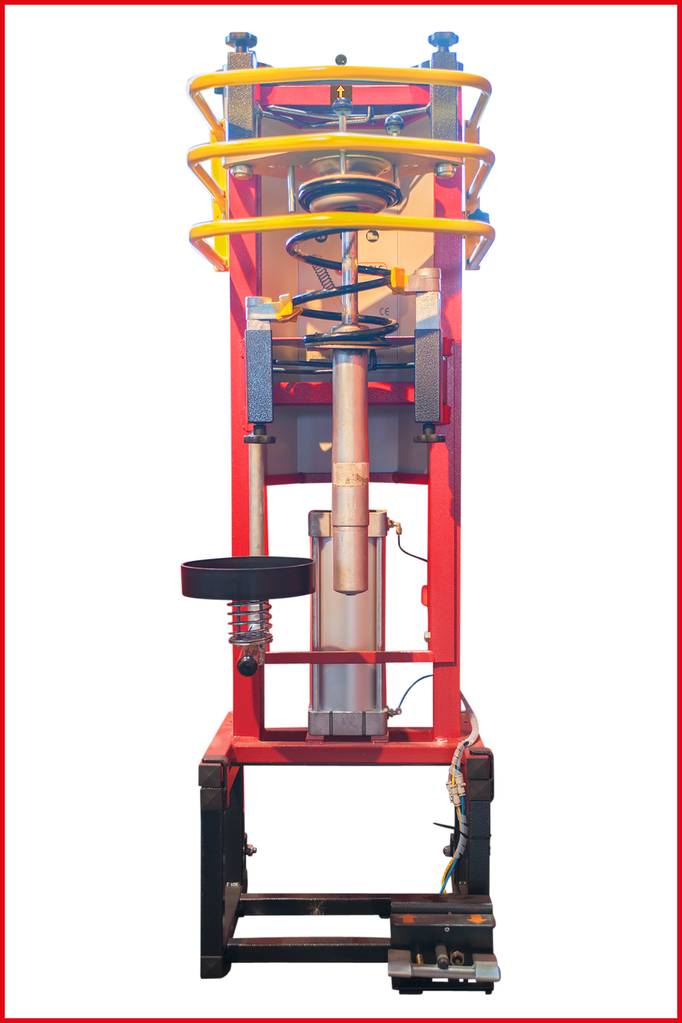 Czerwona pionowa rama maszyny z wieloma sprężynami i silnikiem serwo umieszczonym u dołu. Używana do testów wytrzymałościowych na obciążenia udarowe.