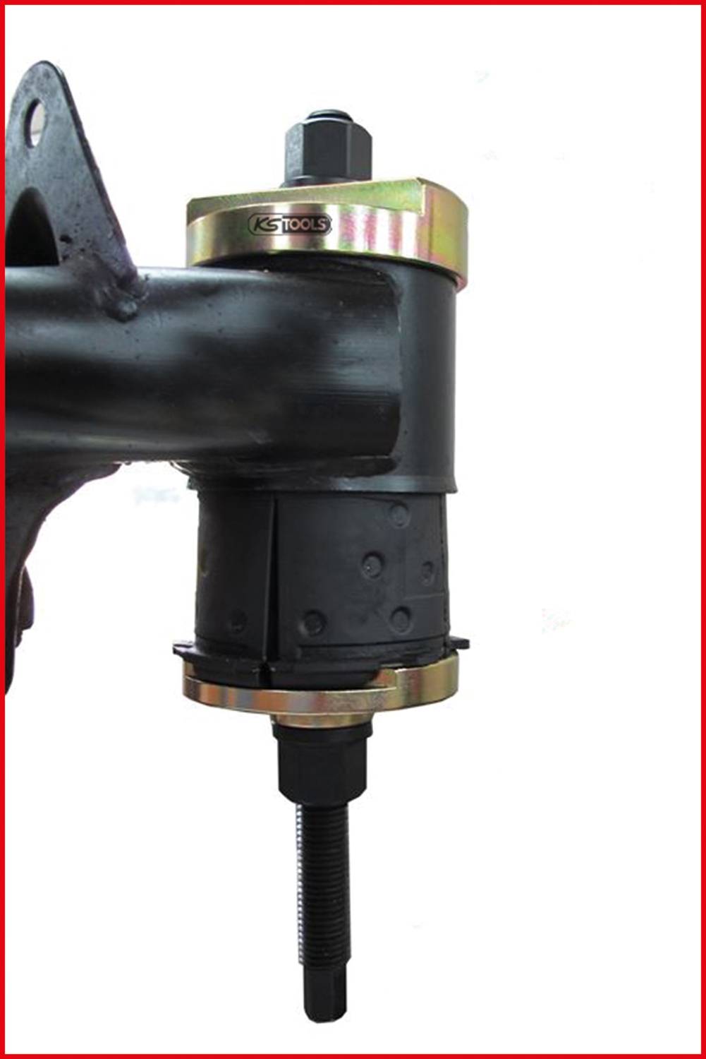 Prasa warsztatowa 'KS TOOLS' ze stabilizatorem z mocowanym na stałe bolcem i metalową ramą, stosowana do montażu i demontażu tulei łożyskowych w osiach pojazdów.