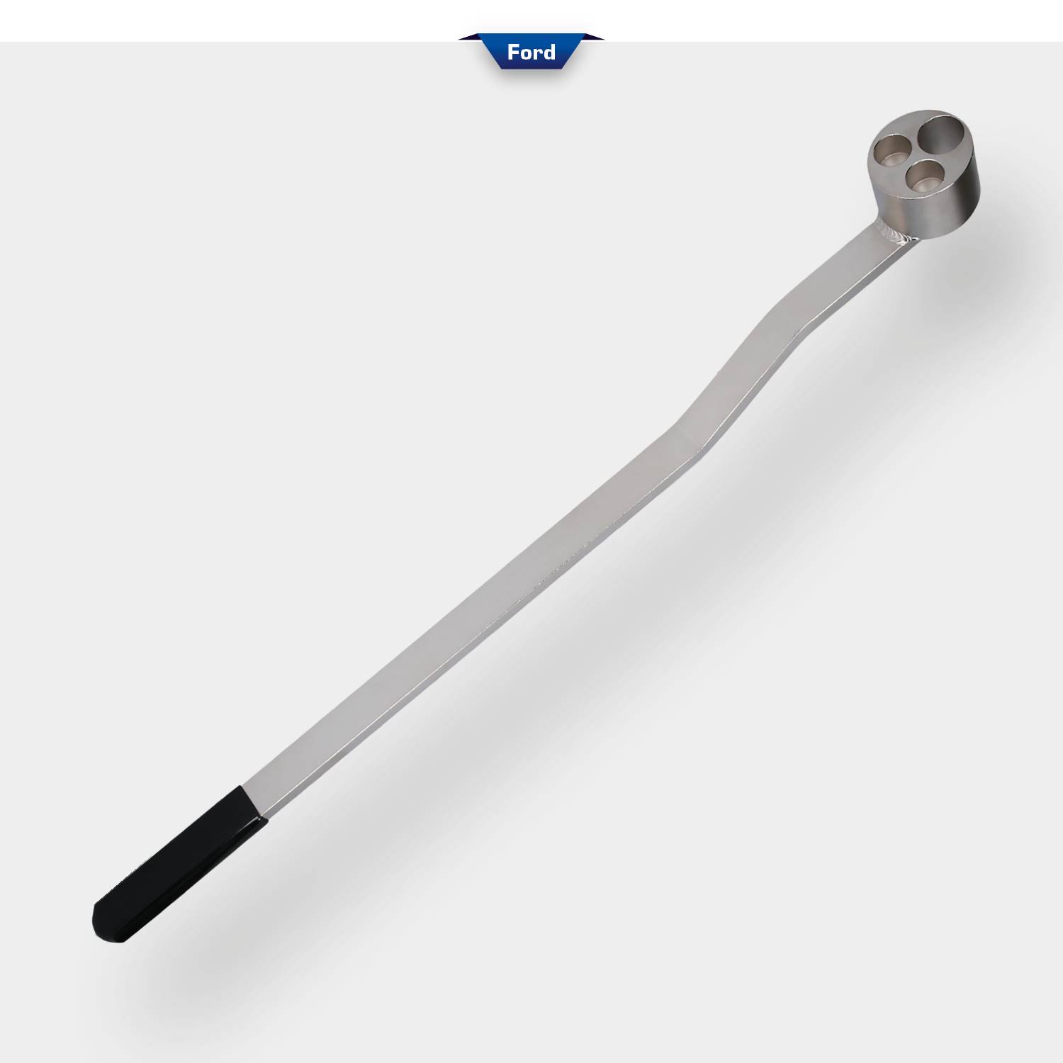 Srebrne metalowe narzędzie z długim uchwytem i głowicą z dwoma okrągłymi otworami. Powyżej widoczne jest logo 'Ford'.