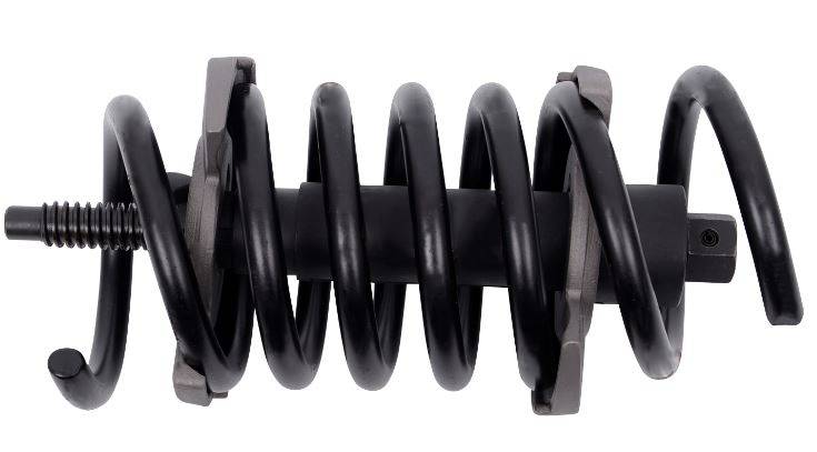 Czarna metalowa sprężyna o zwiniętych zwojach i prostokątnych końcówkach, prawdopodobnie będąca elementem urządzenia mechanicznego lub przemysłowego.