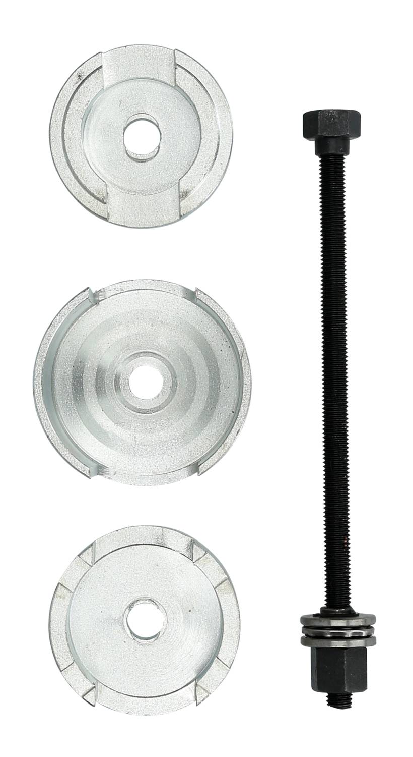 Trzy metalowe krążki i śruba pociągowa z nakrętkami są ułożone obok siebie. Prawdopodobnie służą do montażu lub naprawy.