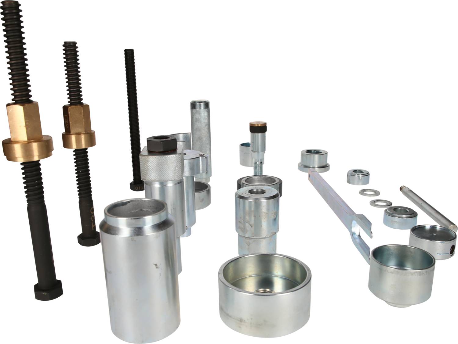 Zestaw metalowy z różnymi cylindrami, śrubami i narzędziami na białym tle, przeznaczony do celów montażowych.