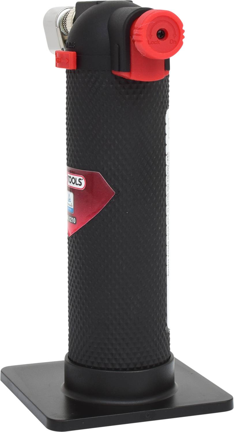 Palnik ręczny z czarną, antypoślizgową powierzchnią i czerwonym pokrętłem na stabilnej, kwadratowej podstawie.