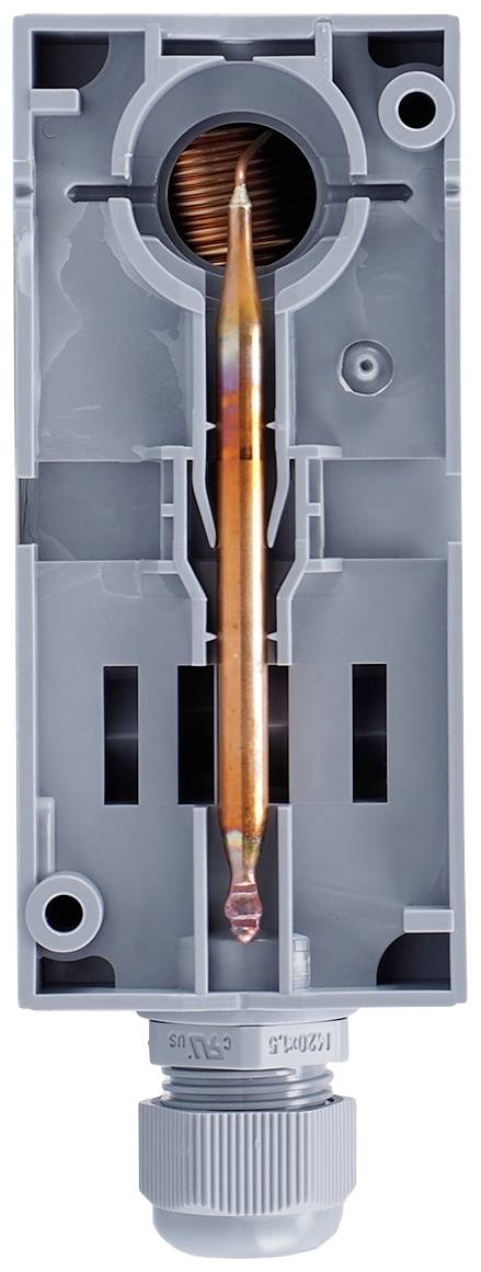 Szary przekrój obudowy elementu elektrycznego z miedzianą cewką i złączem. Ukazuje strukturę wewnętrzną i komponenty.