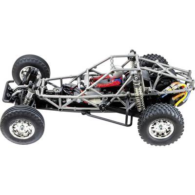 Zdalnie sterowane podwozie samochodu z metalową ramą i widocznym zawieszeniem, oferujące wgląd w złożoną mechanikę i szczegóły techniczne.