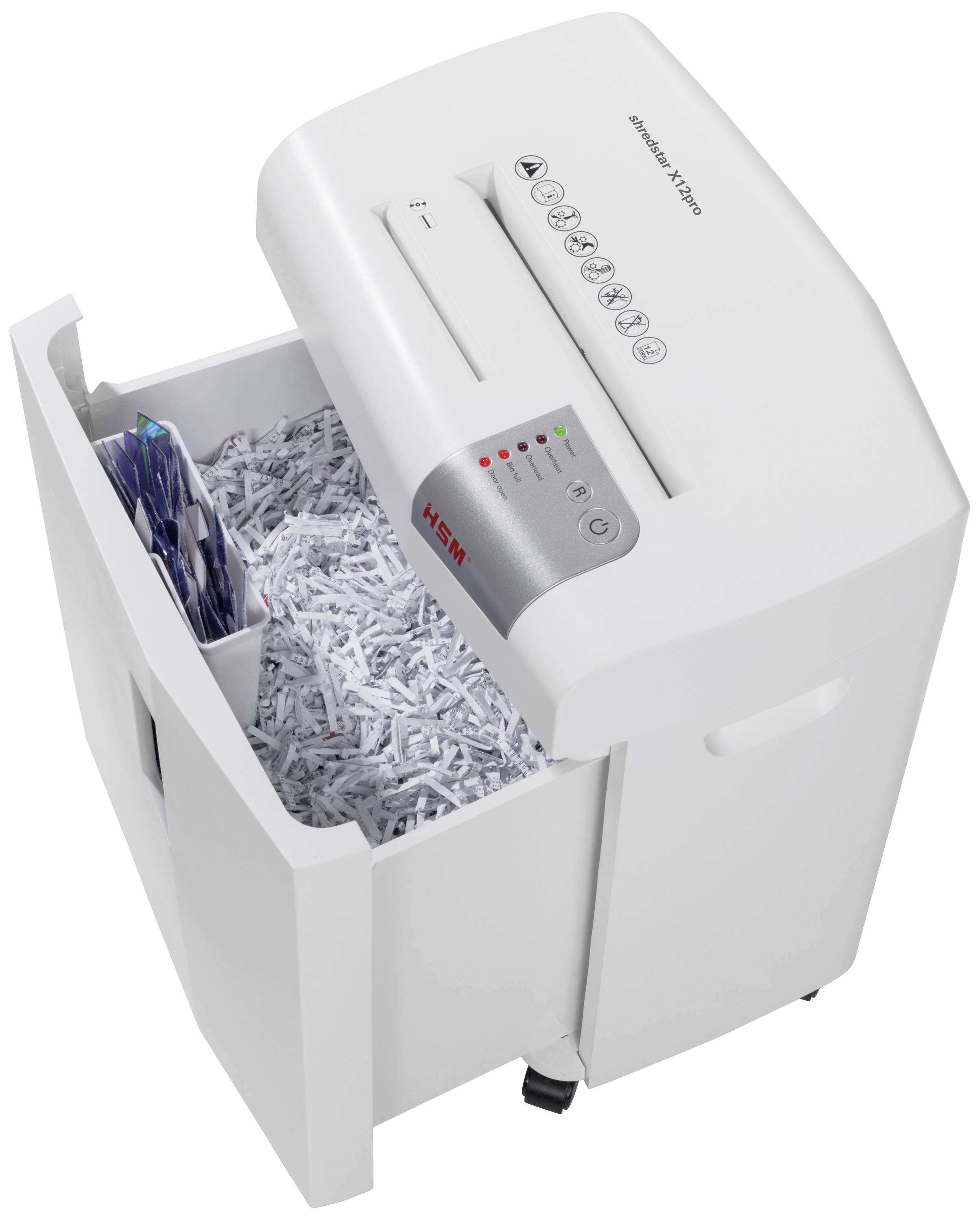 Biały niszczarka dokumentów z otwartym zbiornikiem, wypełnionym pociętymi na kawałki dokumentami. Na panelu widoczne są przyciski i wskaźniki świetlne.