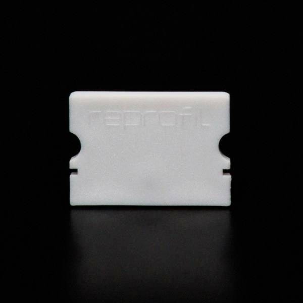 Biały obiekt na czarnym tle, prostokątny z dwoma wcięciami po bokach.