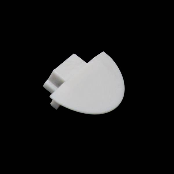 Białowy, półkolisty obiekt z tworzywa sztucznego, posiadający jedną płaską i jedną zaokrągloną stronę, na czarnym tle.