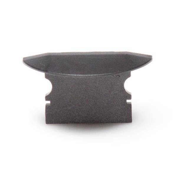 Czarny metalowy element o wygiętej górnej części i ząbkowanych bokach, prawdopodobnie fragment większego mechanizmu.