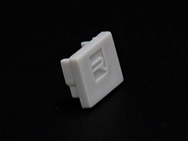 Biała klawisza komputerowa z napisem 'R' na czarnym tle.