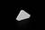 Biały, trójkątny przedmiot leży na czarnym tle.