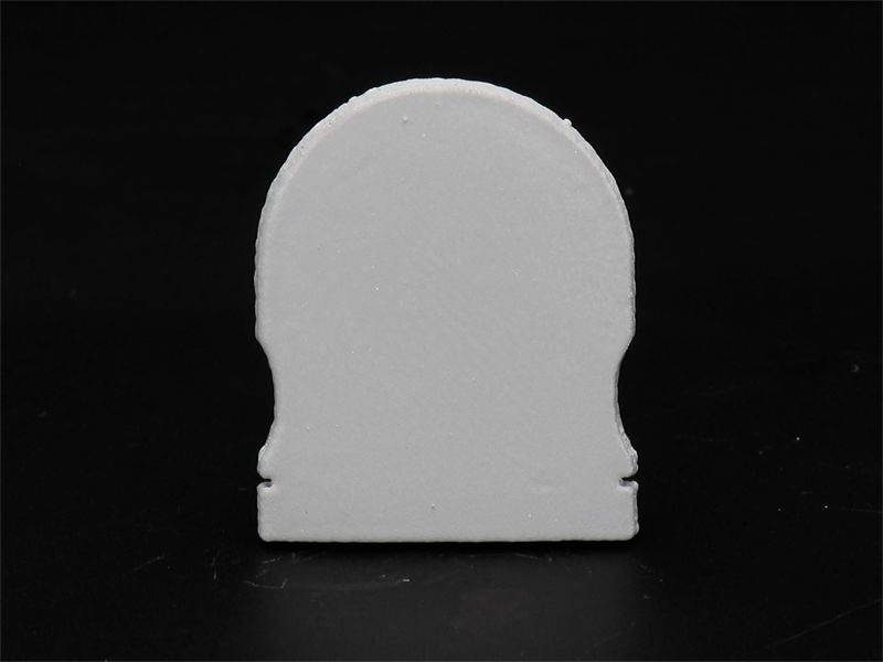 Biała sylwetka nagrobka na czarnym tle.