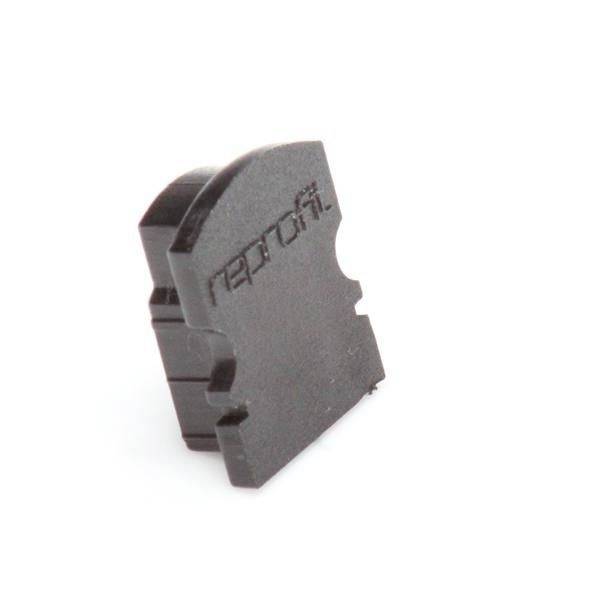 Brązowy element montażowy o prążkowanej powierzchni z napisem „nepros". Wygląda na część techniczną lub przemysłową.