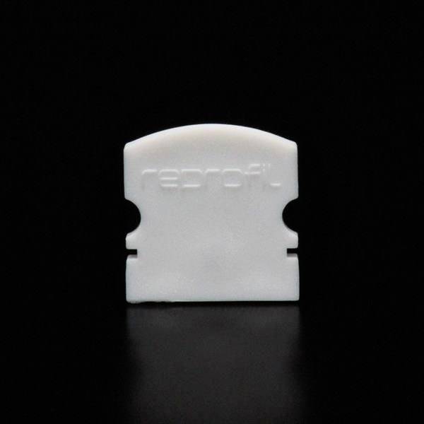 Białi element z tworzywa sztucznego z napisem 'reprofil' na czarnym tle.