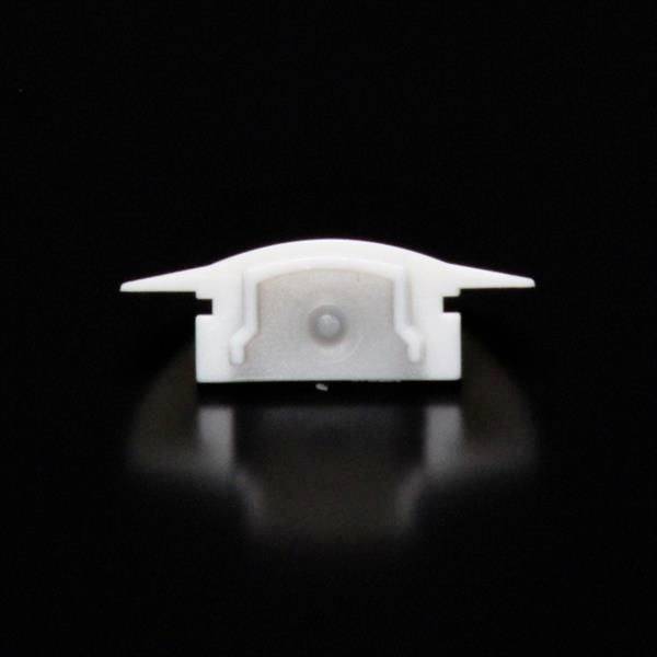 Mała, biała plastikowa podstawka z dwoma bocznymi skrzydełkami, zawieszona na czarnym tle.