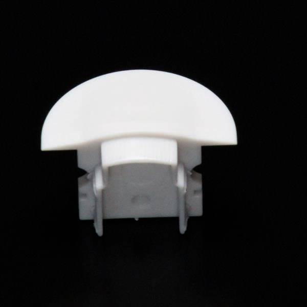 Biały, półokrągły przedmiot z tworzywa sztucznego z dwoma haczykami u dołu, prawdopodobnie zapięcie lub element mocujący na czarnym tle.