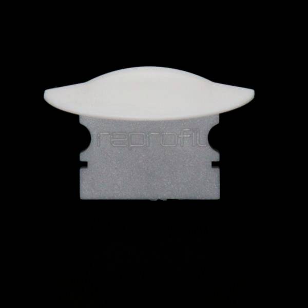 Biało-szara plastikowa część, prawdopodobnie element łączący lub zacisk, na czarnym tle.