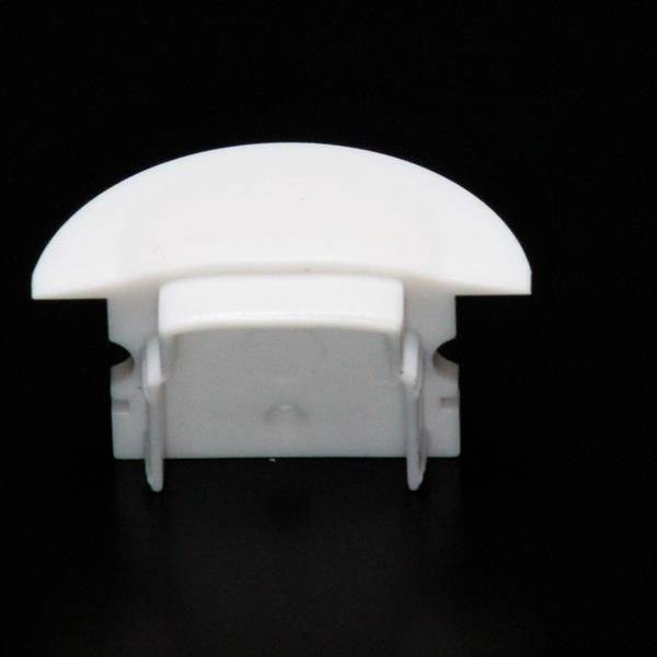 Biały, półkolisty plastikowy klips na czarnym tle, prawdopodobnie element końcowy lub akcesorium do zarządzania przewodami.