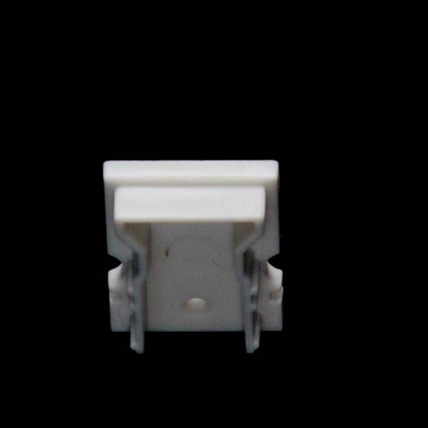 Biały plastikowy klips na czarnym tle, prawdopodobnie uchwyt mocujący lub zacisk do przewodów lub małych przedmiotów.